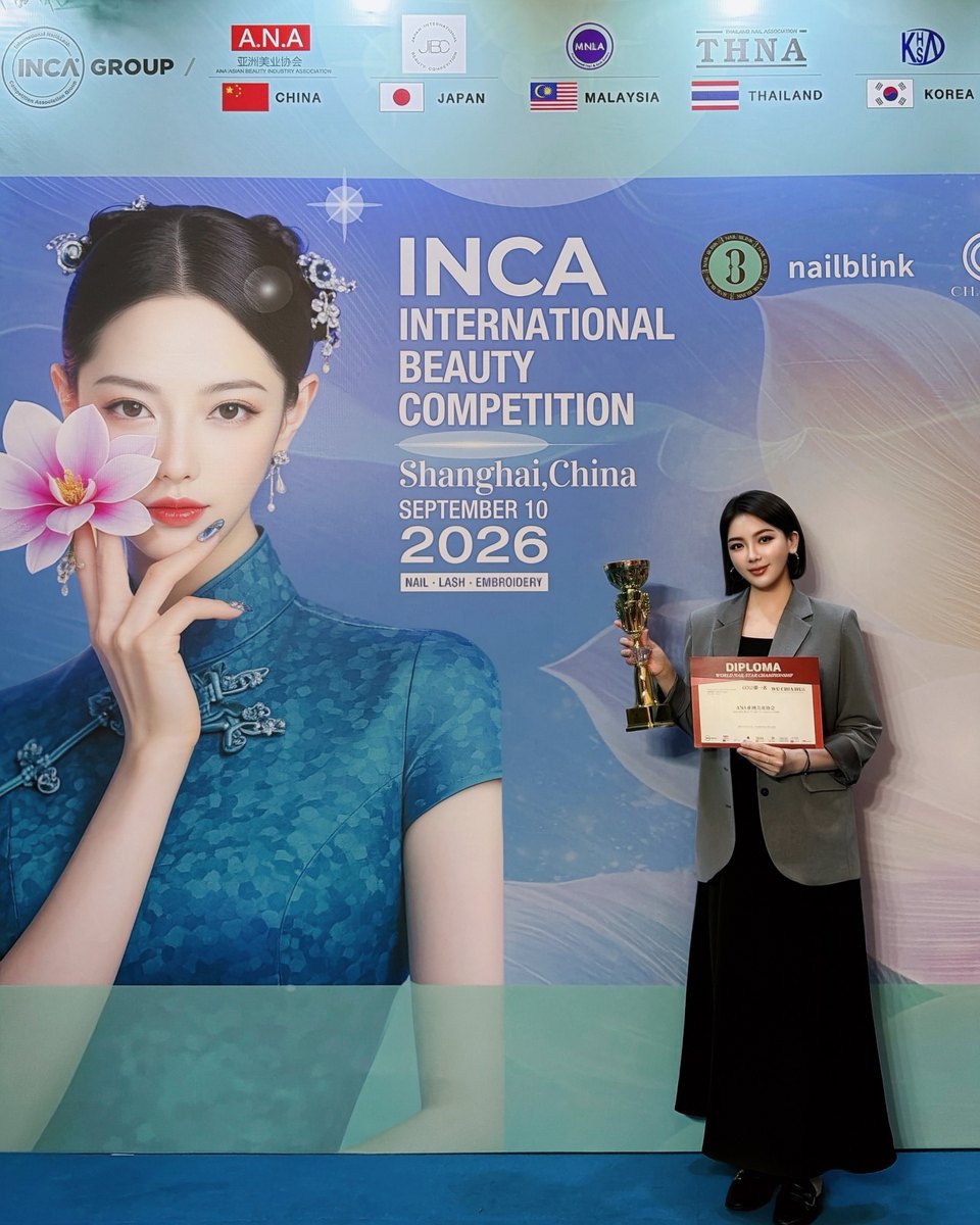 With the trophy and diploma at the INCA International Beauty Competition backdrop, Shanghai, 2026.